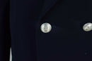 Close-up of silver buttons on a genuine Italian Carabinieri military police trench coat with dark fabric.