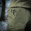 Close-up of olive green M-TAC military style tactical combat pants with ripstop fabric and pocket knife clip visible