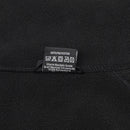 Close-up of black MIL-TEC fleece pullover showing care label and polyester fabric texture