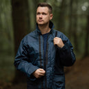 Man wearing original British RAF waterproof foul weather parka lined raincoat in blue outdoors