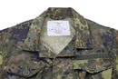 Close-up of TACGEAR Flecktarn camo jacket with ripstop fabric, buttoned pockets, and reinforced collar detail