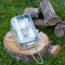 BCB Outdoor hiking cooking set with mess tins, cutlery, fire striker, and can opener on a tree stump outdoors