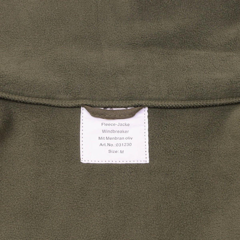 Close-up of olive green Blochl brand fleece jacket label showing size M and windbreaker features