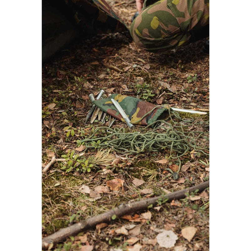 Camouflage pouch with metal tent stakes and green rope for assembling a Belgian military two-person waterproof tent.