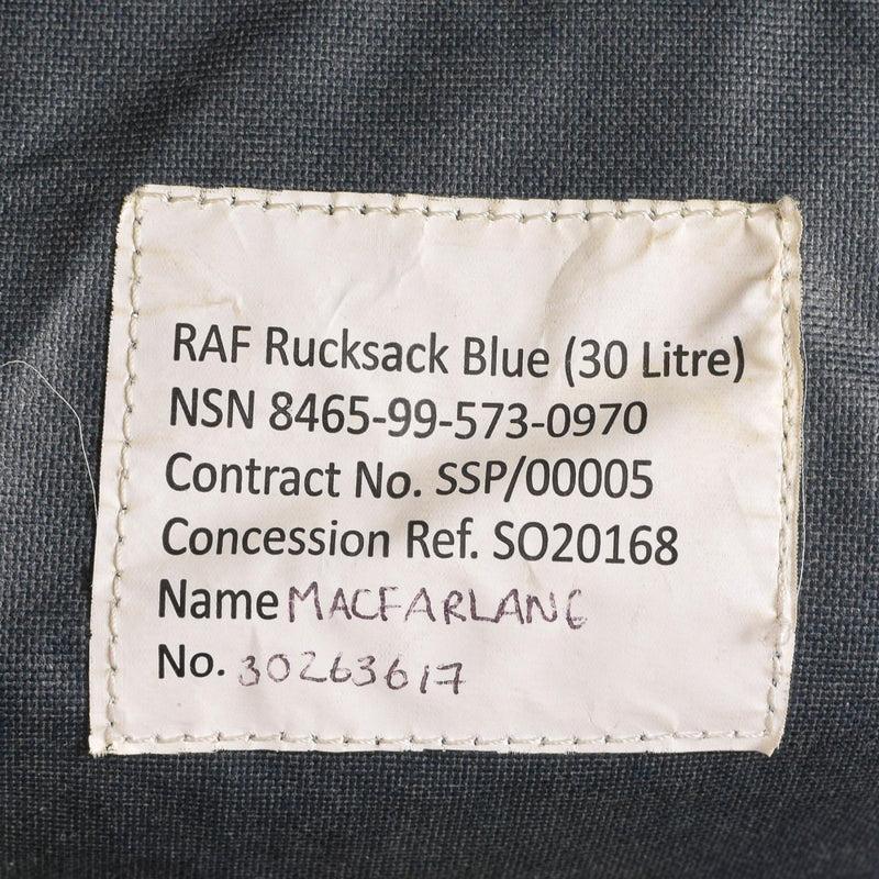 Close-up of the stitched label inside a blue Royal Air Force 30-liter rucksack with serial and contract details.