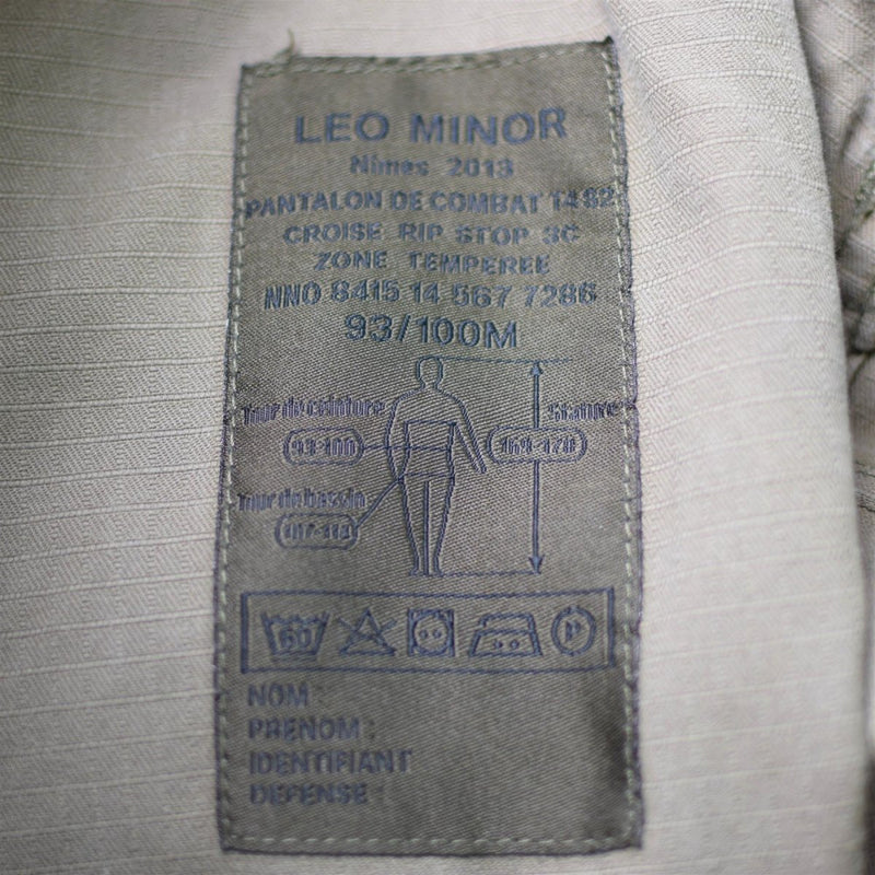 Close-up of a fabric label showing sizing and care instructions inside Genuine French Army FELIN combat pants.
