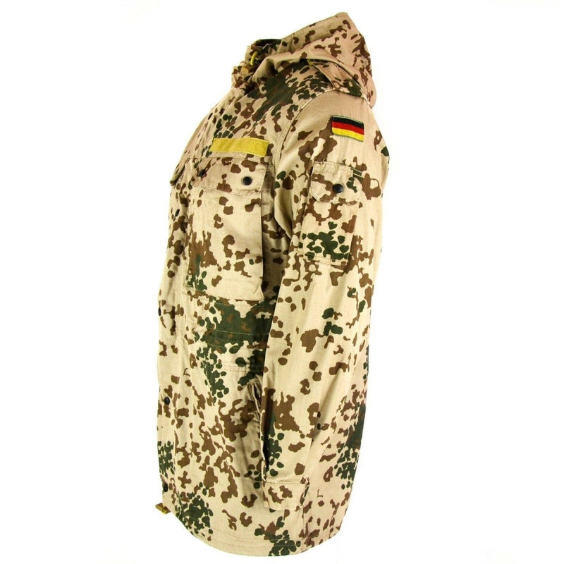 Side view of a genuine German army desert flecktarn camouflage field jacket with hood and multiple pockets.