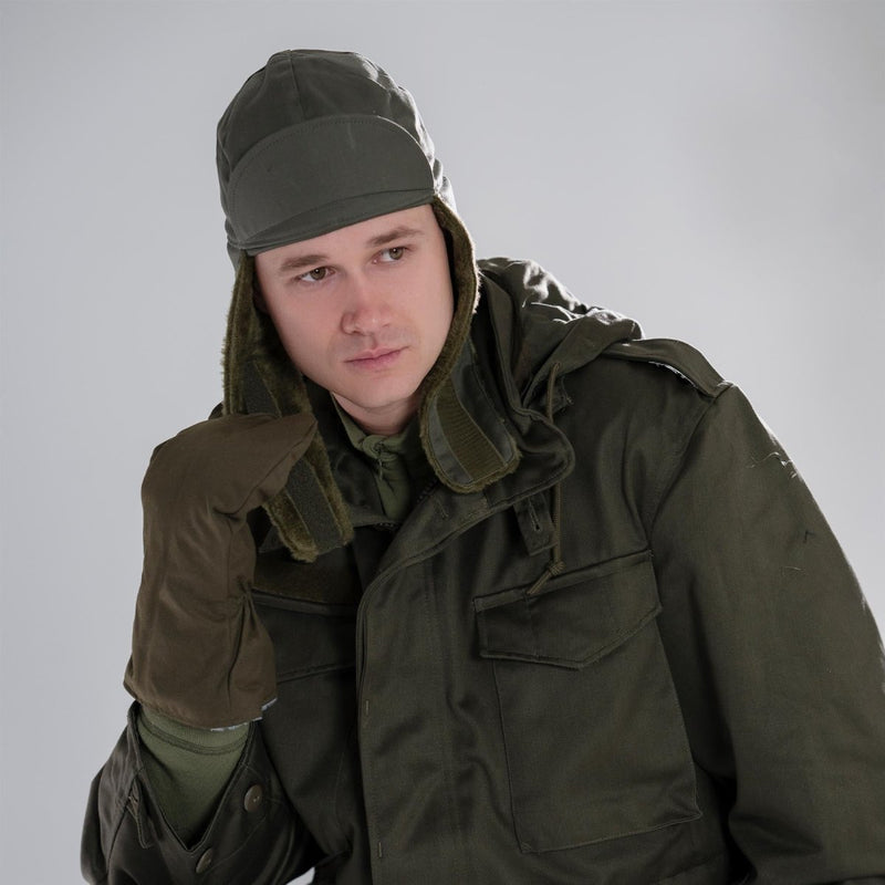 Man wearing genuine German Army olive drab winter pile cap with ear flaps and matching cold weather military jacket