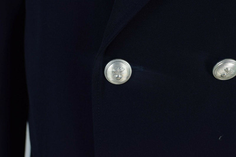Close-up of silver buttons on a genuine Italian Carabinieri military police trench coat with dark fabric.