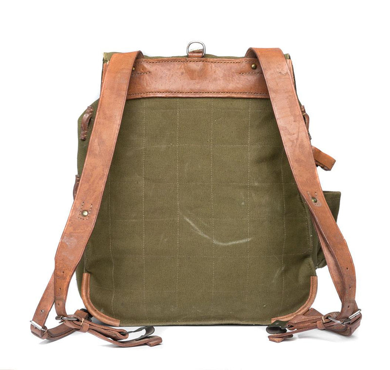 Genuine Romanian army rucksack made of olive drab canvas with brown leather shoulder straps and secure buckles.