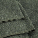 Close-up of dark green fabric with a textured surface