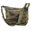 Camouflage Helikon-Tex Bushcraft Satchel bag with adjustable strap, MOLLE panels, and multiple zippered pockets for outdoor use.