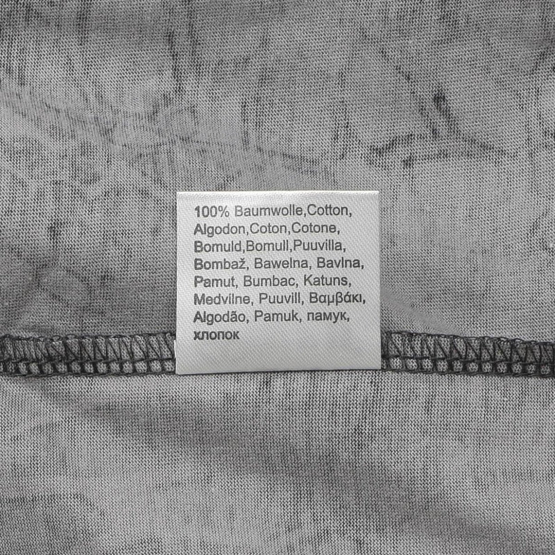 Close-up of a fabric label on a grey military-style T-shirt showing 100% cotton material in multiple languages
