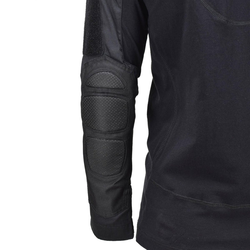 Close-up of Mil-Tec black tactical combat shirt sleeve with reinforced elbow padding and breathable fabric details.