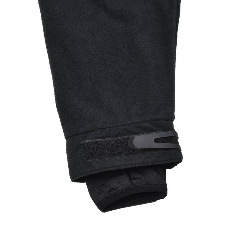 Close-up of black MIL-TEC fleece jacket sleeve with adjustable Velcro wrist strap for cold weather and activewear use