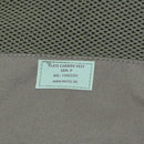 Close-up of MIL-TEC GEN II tactical plate carrier vest label in olive with mesh and durable fabric details