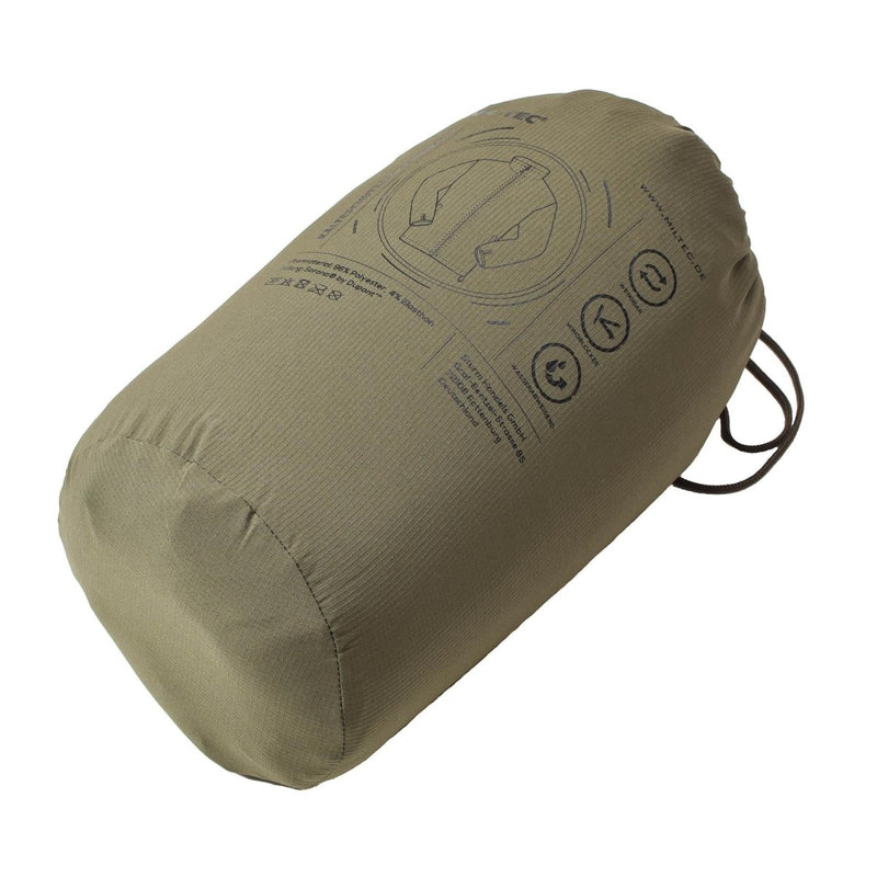 Packed MIL-TEC German Military reversible cold weather jacket in olive green storage bag for outdoor use
