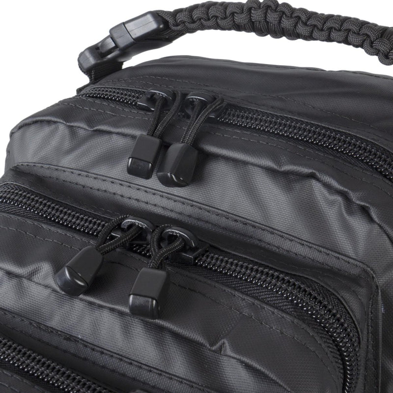Close-up of zippered compartments and sturdy fabric on the black MIL-TEC U.S. Assault tactical backpack 20L daypack.