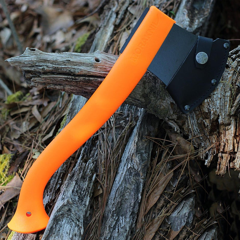 MORAKNIV lightweight orange camping axe with black ED-coated boron steel blade and leather edge cover on tree bark.