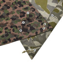 Close-up of vintage Austrian army pea dot splinter camo poncho tent corners with metal grommets and tie strings.