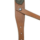 Close-up of a vintage brown leather Austrian Army Y-Strap suspender with dated stamping and metal rivet details
