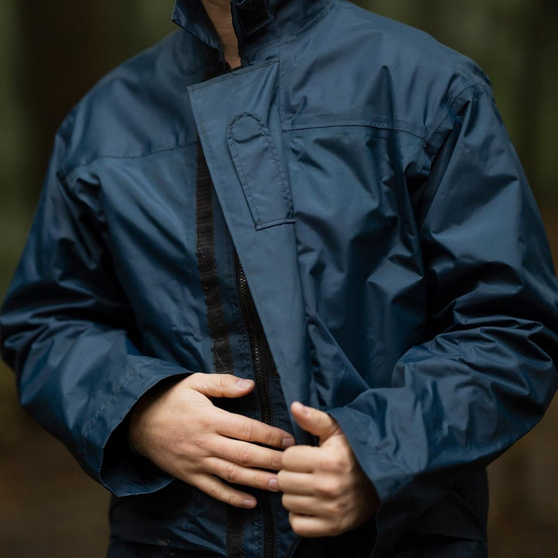 Close-up of a person wearing a blue original British RAF waterproof foul weather parka raincoat outdoors