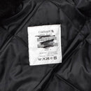 Close-up of quilted black liner with Carhartt label inside Dutch military work coverall jumpsuit