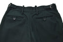 Dark green wool dress trousers with adjustable waist buckles and rear button pockets, inspired by Irish military style.
