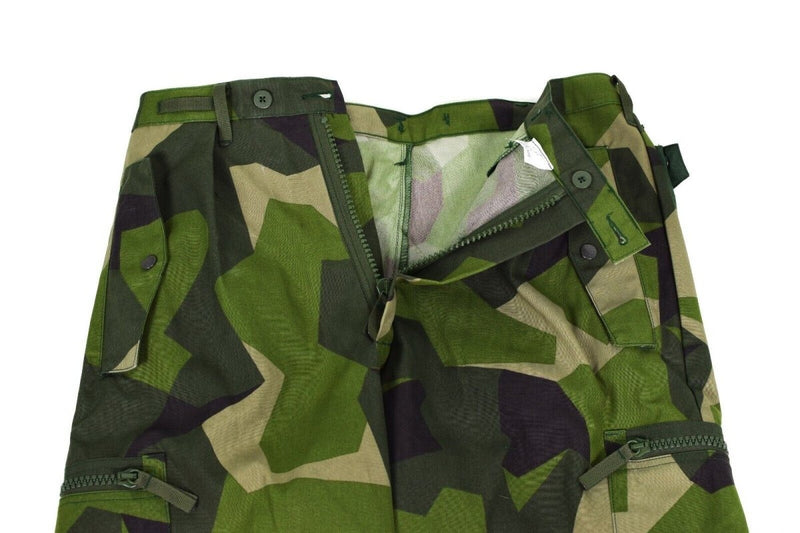Close-up of original Swedish Army M90 splinter camouflage combat pants with zipper and button details visible
