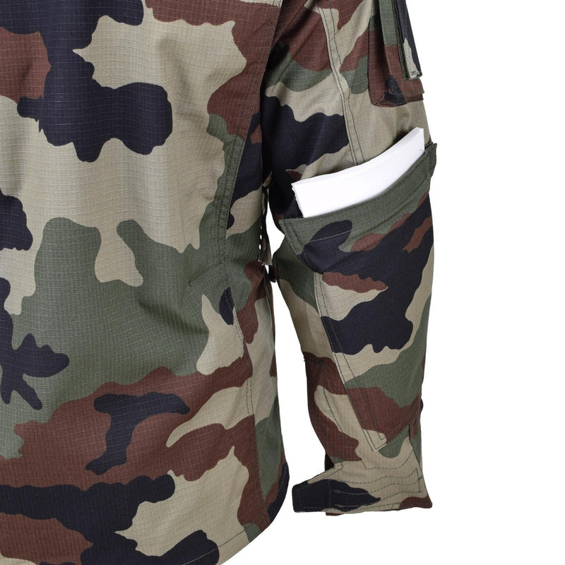 Close-up of TACGEAR French military style camo commando jacket sleeve with utility pocket holding a white item