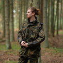 Man wearing TACGEAR German military style Flecktarn smock jacket with YKK zipper in a forest setting